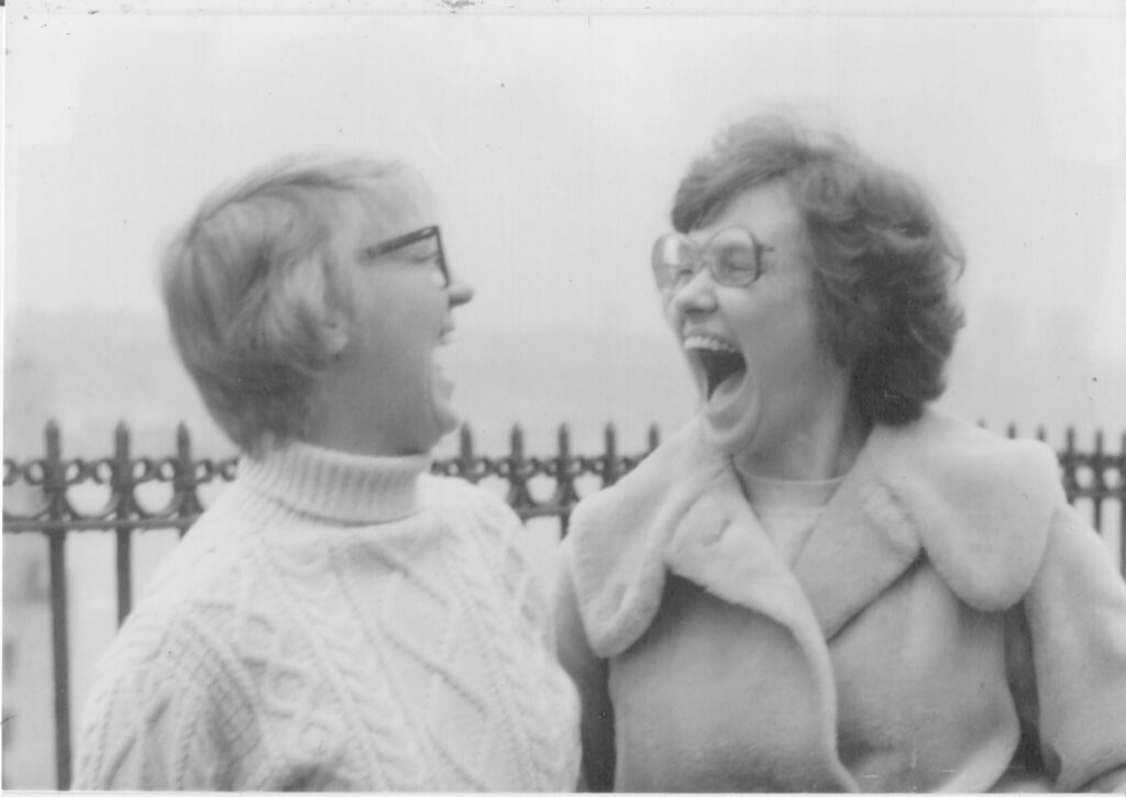 Black and white image of two women laughing