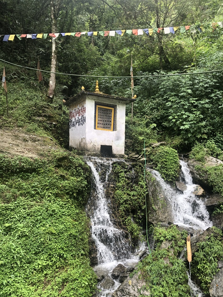 waterfall and small building